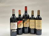 six bottles of wine are lined up on a white surface