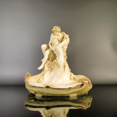 an image of a statue of a woman sitting on top of a shell