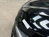 cars parked in a parking lot with a price tag attached to the hood of the car