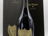 the bottle of champagne is next to a black box