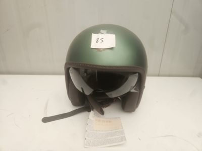 a green helmet with a tag on it on a table