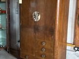 a wooden cabinet with a door and a glass case