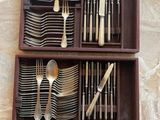 a wooden box with silverware in it on a table