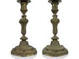 pair of antique brass candlesticks on a white background