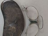 a pair of glasses and a pair of eyeglasses on a table