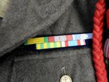 a medal pinned to the back of a man ' s jacket