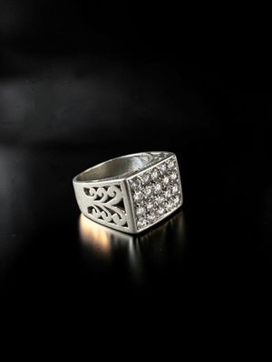 a close up of a silver ring on a black surface