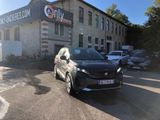 a black car parked in front of a building