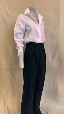 a male mannequin dressed in a white shirt and black pinstripe pants