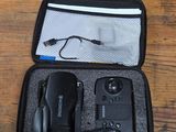 a black case with a remote control and other items in it