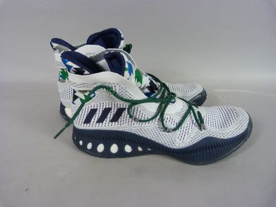 adidas basketball shoes with green laces and a white background