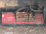 a red machine that is sitting in the dirt