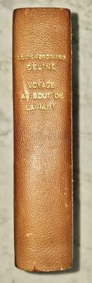 un vieux livre à la couverture en cuir posé sur une surface en marbre