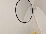 a toilet with a mirror and a bunch of items in it