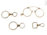 four pairs of eyeglasses and a ring on a white background