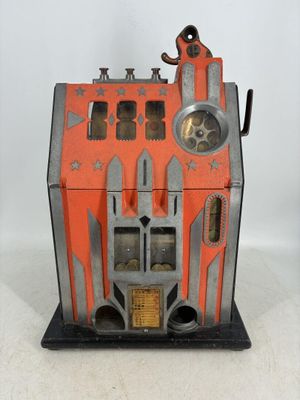 a small toy house with a clock on top of it