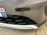 a close up of a car ' s front bumper with a sticker on it