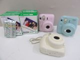 three cameras sitting next to each other on a table