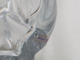 a glass vase with a flower on it on a table