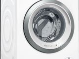 the front view of a white washing machine with the door open