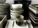 many plates and bowls stacked on top of each other