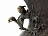 a close up of a vase with a monkey on it
