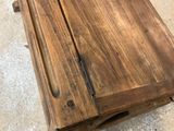 a close up of a wooden table with a drawer underneath it