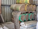 a stack of rolls of cement in a storage area