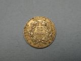 a close up of a gold coin on a gray surface