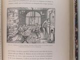 an open book with a picture of a woman in a kitchen