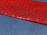 a close up of a red tie on a blue surface
