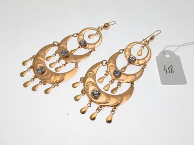 two pairs of gold tone earrings with crystals on them