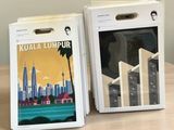 two boxes with a picture of a city on them sitting on a table