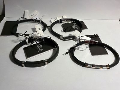 three black leather bracelets with silver clasps on a white surface