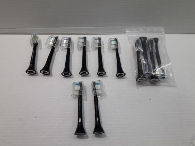 several toothbrushes are lined up in a row on a table