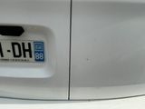 a close up of a car ' s license plate on a white car