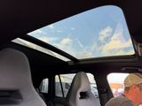 a man that is sitting in the back seat of a car