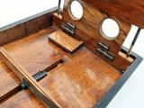 a small wooden box with a mirror on top of it
