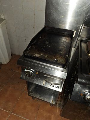 a stove and a toilet in a small room