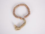 a close up of a wooden beaded bracelet with a tassel on it