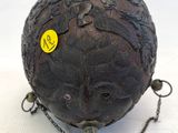 a ball with a chain around it that has a face on it