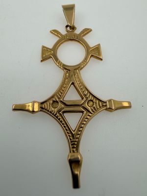 an image of a gold cross on a white surface