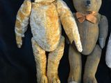 three teddy bears sitting next to each other on a black background