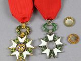 two medals and a medal on a gray surface