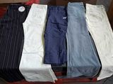 five pairs of men ' s pants sitting on a pallet