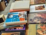 several books are stacked on top of each other on a table