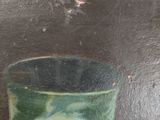 a painting of a glass of orange juice on a table