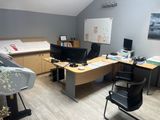 a room with a desk, chair, and computer monitor in it