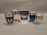 four different types of perfumes in a box on a table