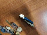 many different watches on a table with a watch on it